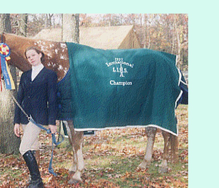 Tricia with her champion horse wearing an invitational blanket