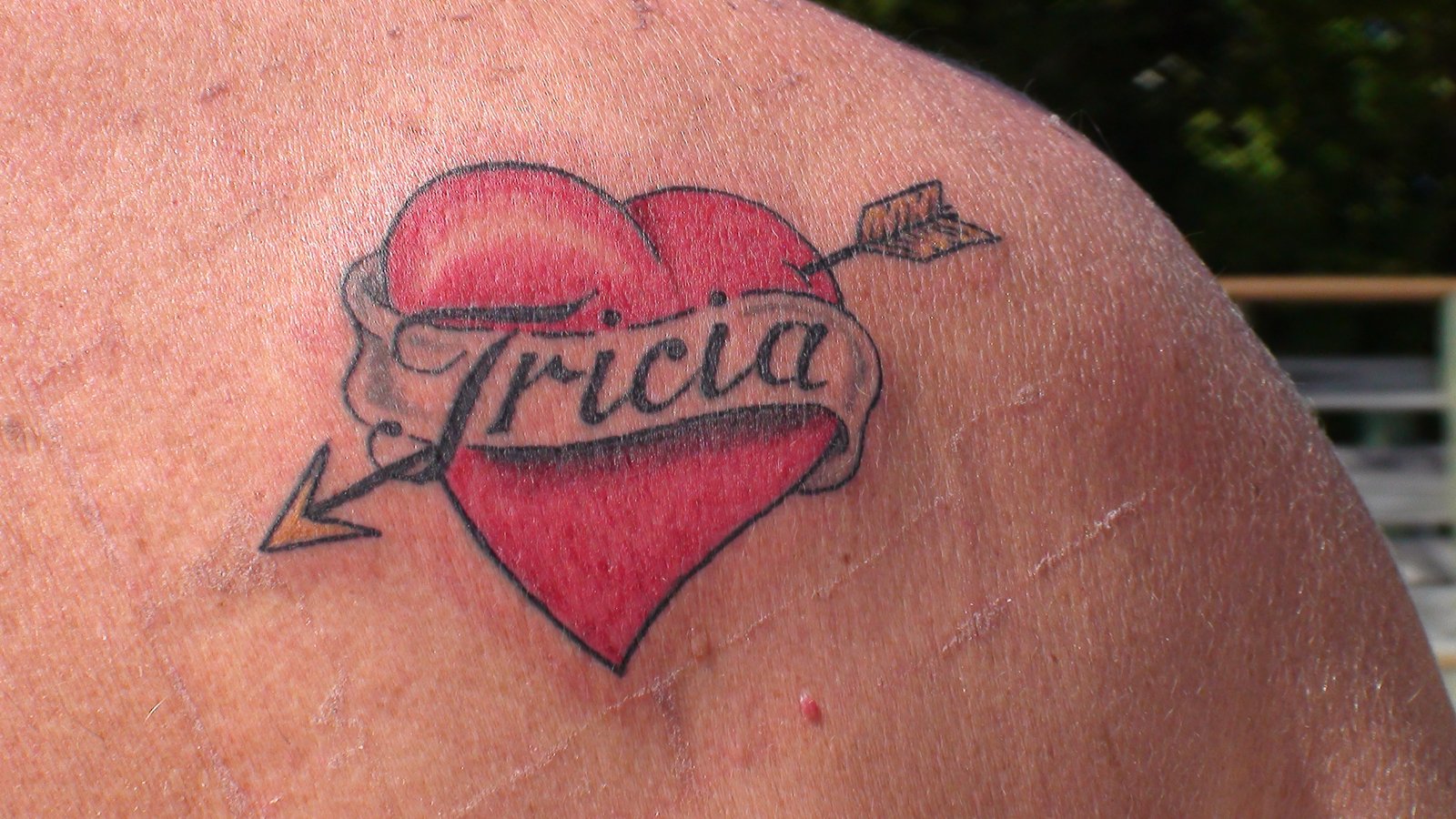 Tricia’s dad’s memorial tattoo — a red heart with a banner reading Tricia